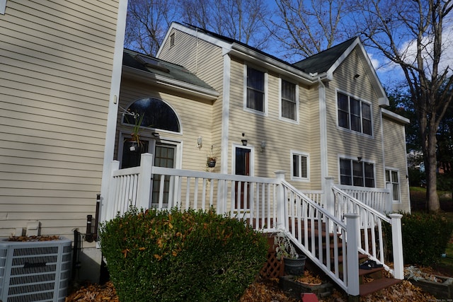 view of side of home featuring central air condition unit and a wooden deck