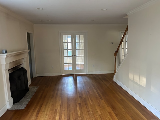 unfurnished living room featuring dark wood-type flooring, crown molding, and french doors