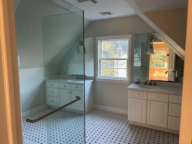 bathroom with a wealth of natural light, vanity, and vaulted ceiling