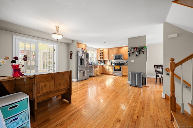 living room with sink and light hardwood / wood-style floors