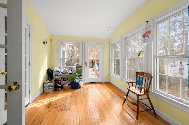 sunroom featuring vaulted ceiling