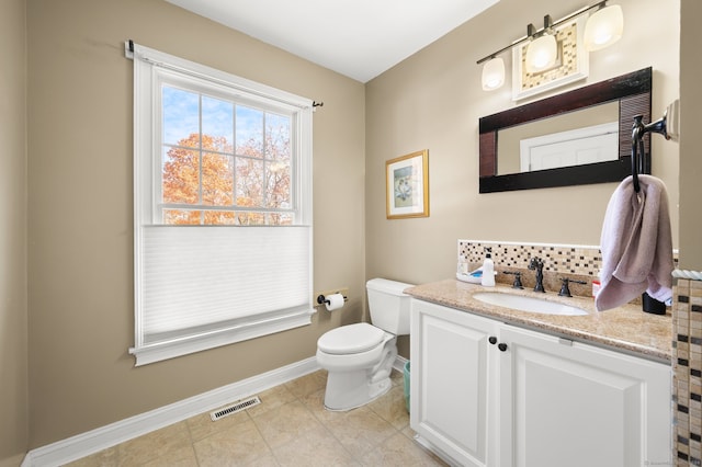 bathroom with vanity, toilet, and tile patterned floors