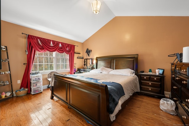 bedroom featuring wood-type flooring and vaulted ceiling