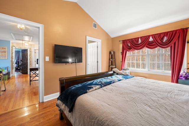 bedroom featuring wood-type flooring and lofted ceiling