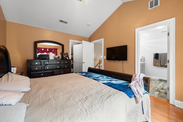 bedroom featuring lofted ceiling and light wood-type flooring