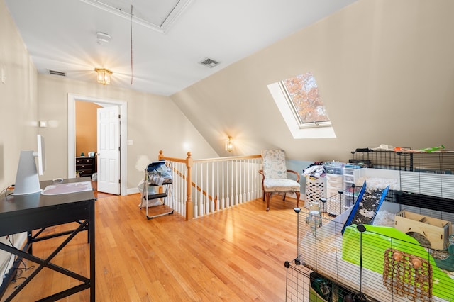 interior space featuring hardwood / wood-style flooring and vaulted ceiling