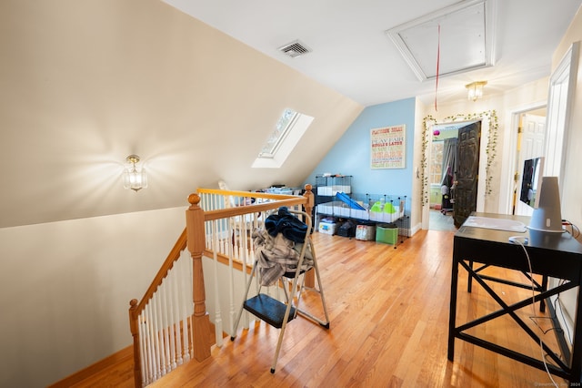 bedroom with hardwood / wood-style floors and vaulted ceiling