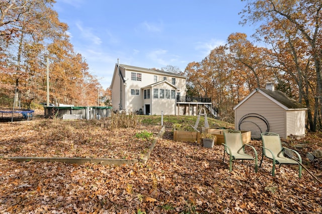 back of house with a trampoline