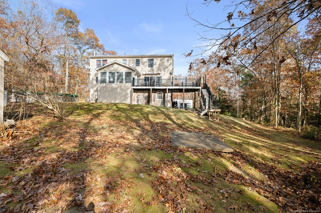 back of house featuring a wooden deck