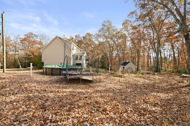 view of yard with a storage unit and a trampoline