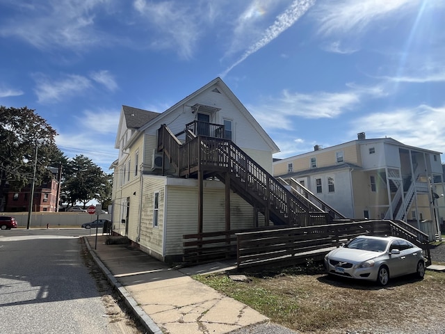 22-26 Hunters Ave, Norwich, CT 06380 - view of front of home with stairs, a balcony, and a shingled roof