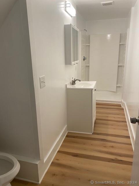 22-26 Hunters Ave, Norwich, CT 06380 - full bathroom featuring a stall shower, vanity, and wood finished floors