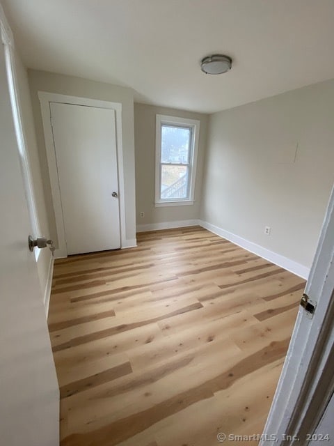 unfurnished bedroom with light wood-type flooring