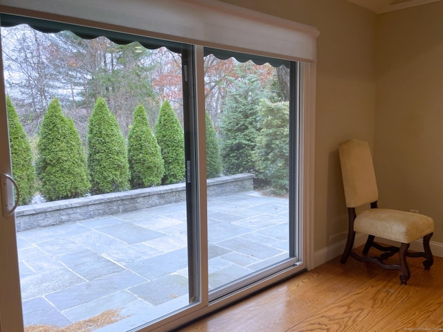entryway with wood finished floors and baseboards