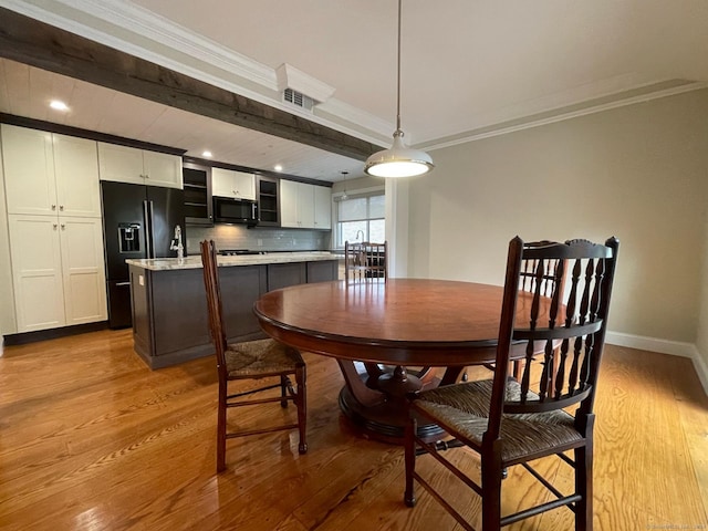 dining area with crown molding, recessed lighting, wood finished floors, and baseboards