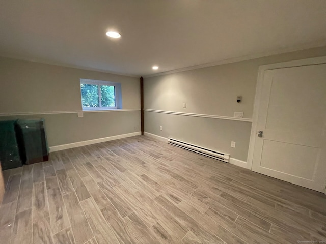 interior space with baseboard heating and hardwood / wood-style flooring