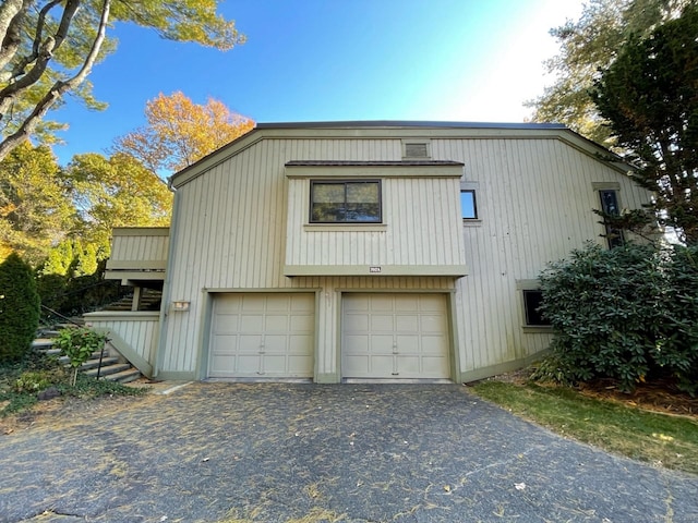 garage featuring aphalt driveway