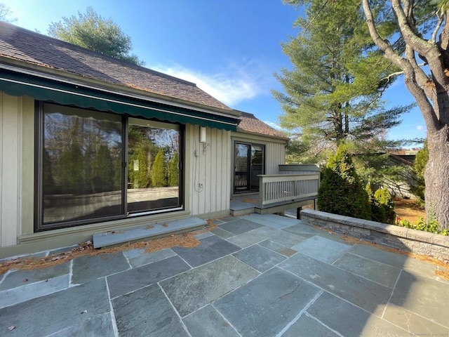 view of exterior entry featuring a patio