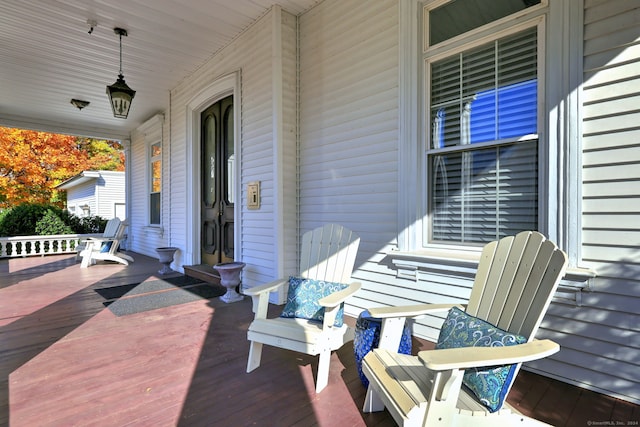 wooden terrace featuring covered porch