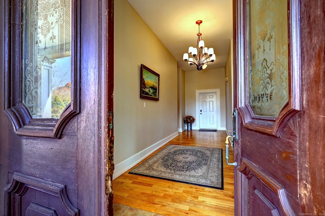 entryway with a chandelier and hardwood / wood-style floors