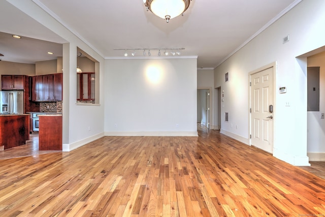 unfurnished living room with ornamental molding, electric panel, light wood-type flooring, and rail lighting