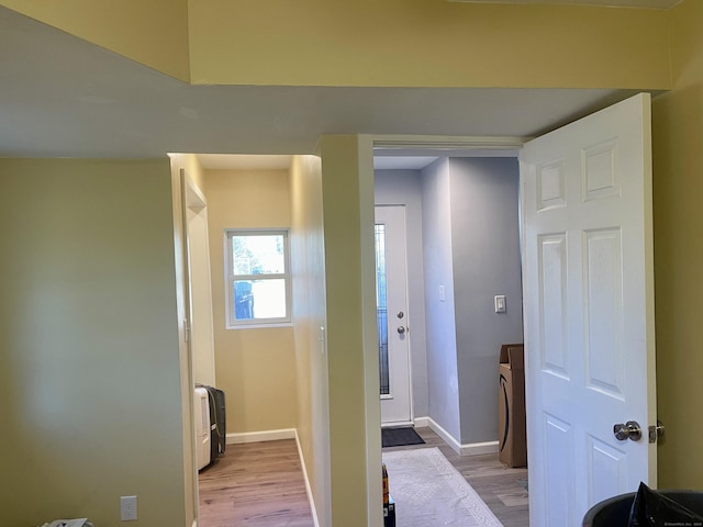 interior space with washer / clothes dryer and light hardwood / wood-style floors