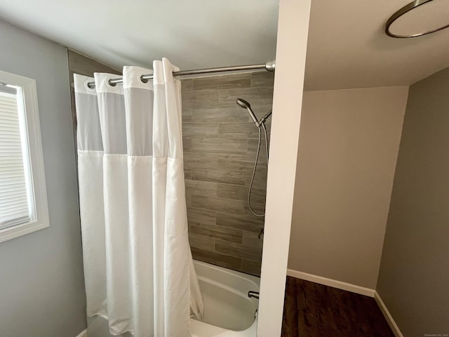 bathroom featuring shower / tub combo with curtain and hardwood / wood-style flooring