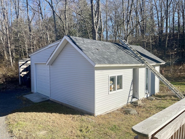 view of side of property featuring an outbuilding and a garage