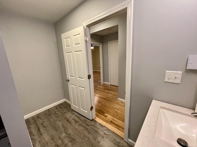 bathroom with sink and wood-type flooring