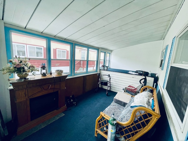 sunroom / solarium with a healthy amount of sunlight and wood ceiling