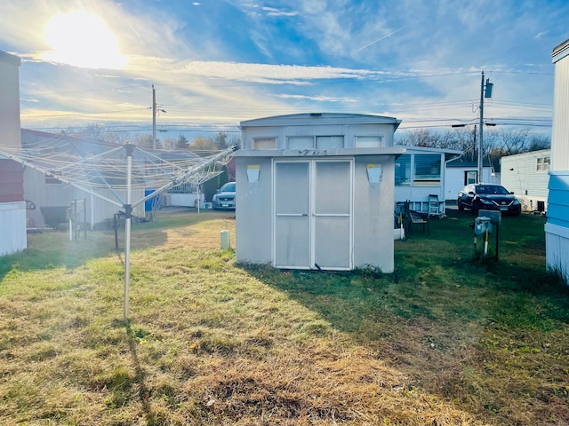 view of outbuilding featuring a yard