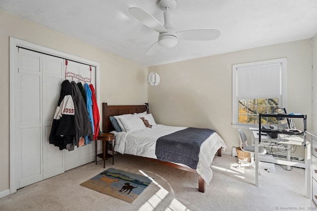 carpeted bedroom with ceiling fan and a closet