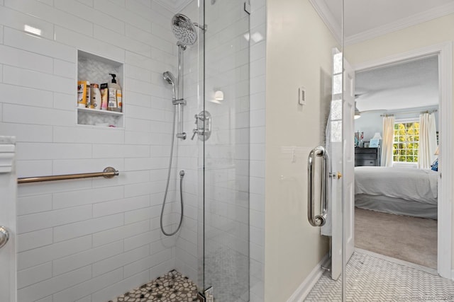 bathroom featuring a shower with shower door and crown molding