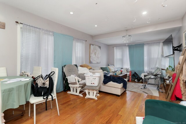 living room featuring light hardwood / wood-style floors and a notable chandelier