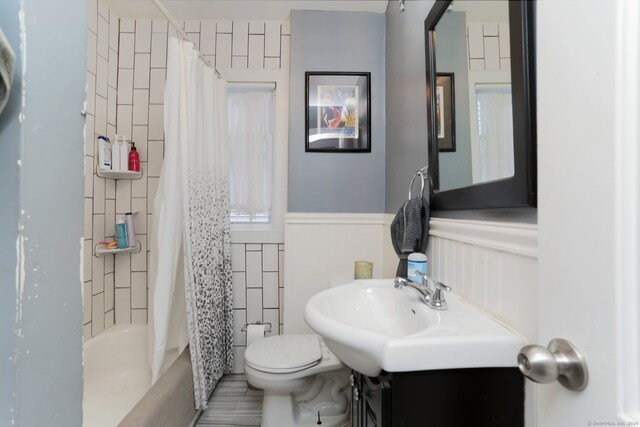 full bathroom with vanity, toilet, and shower / bath combo with shower curtain