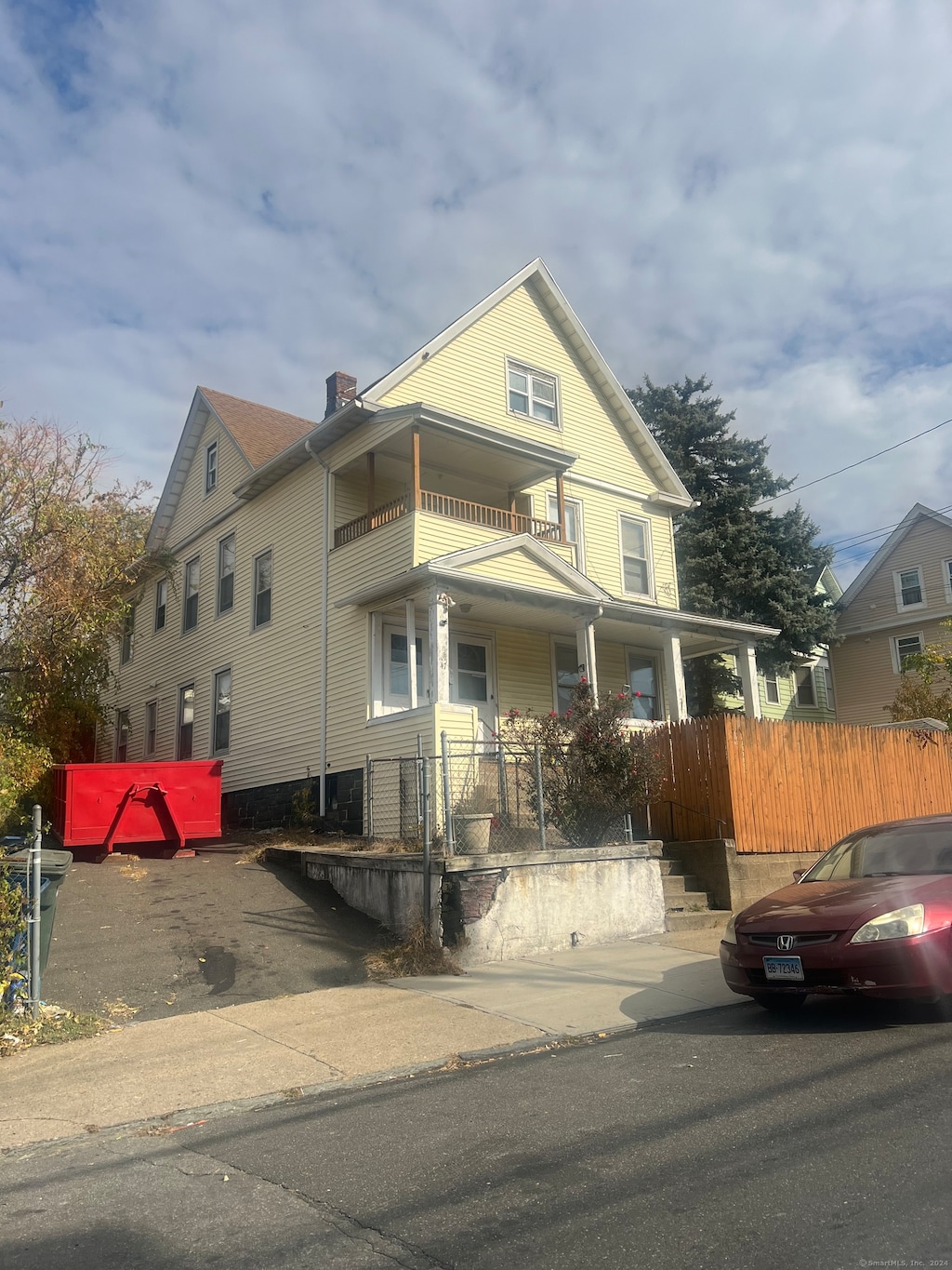 view of front of property with a balcony and a porch