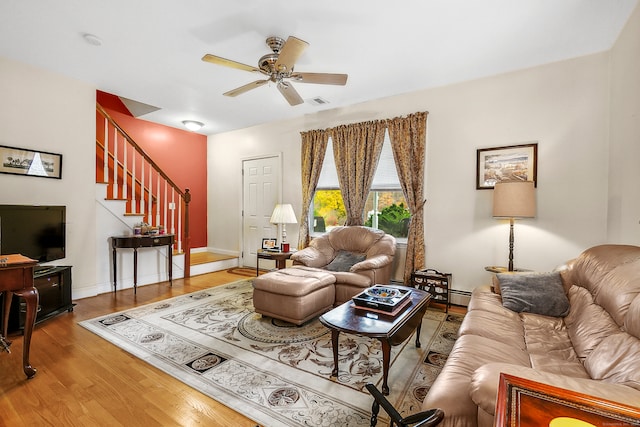 living room featuring wood-type flooring and ceiling fan