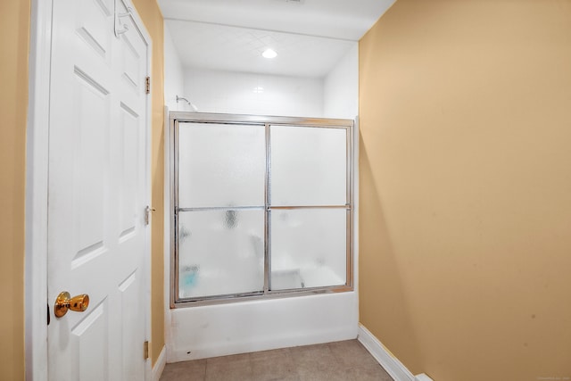 bathroom with tile patterned floors and combined bath / shower with glass door