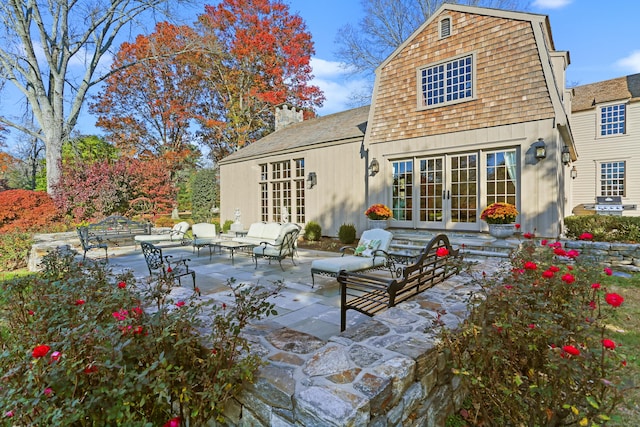 back of property featuring outdoor lounge area, a patio area, and french doors