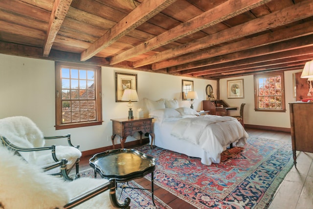 bedroom featuring beam ceiling, wood ceiling, and light hardwood / wood-style flooring