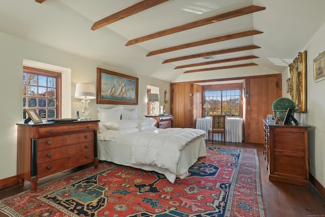 bedroom featuring vaulted ceiling with beams, radiator heating unit, and dark wood-type flooring