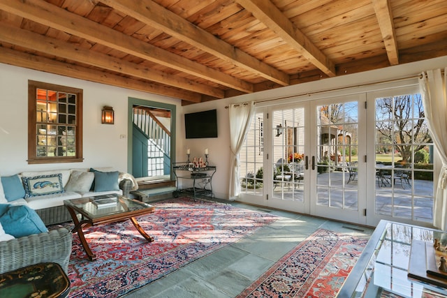 sunroom / solarium with beamed ceiling, wooden ceiling, and french doors