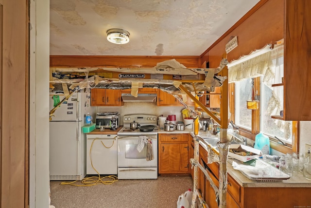 82 Pendleton Hill Rd, Voluntown, CT 06384 - kitchen with white appliances, under cabinet range hood, brown cabinets, and light countertops