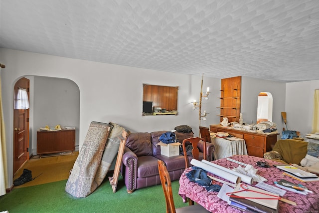 82 Pendleton Hill Rd, Voluntown, CT 06384 - carpeted living room with arched walkways and a textured ceiling