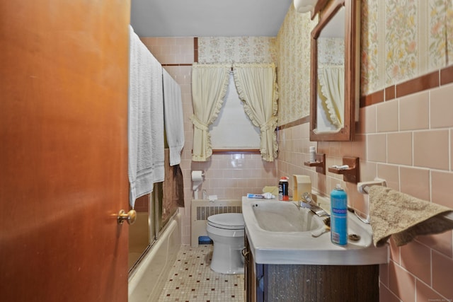 82 Pendleton Hill Rd, Voluntown, CT 06384 - bathroom featuring tile walls, vanity, shower / bath combination with glass door, tile patterned floors, and radiator