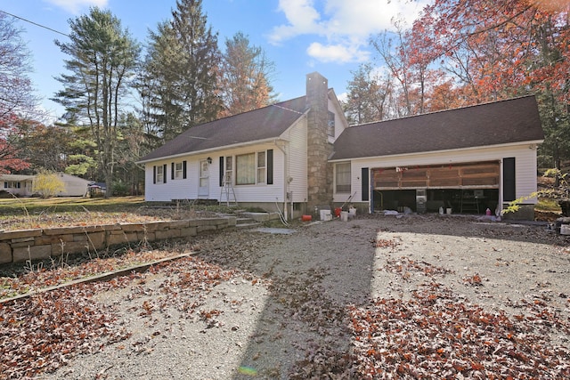 82 Pendleton Hill Rd, Voluntown, CT 06384 - view of front of home featuring a chimney, dirt driveway, an attached garage, and roof with shingles