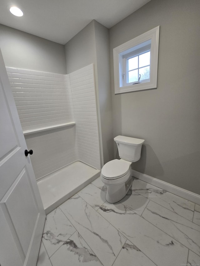 bathroom featuring toilet and walk in shower