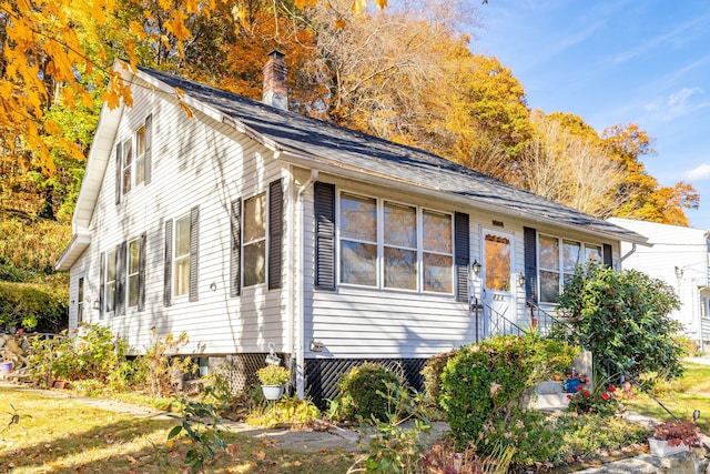 view of front of house featuring a chimney