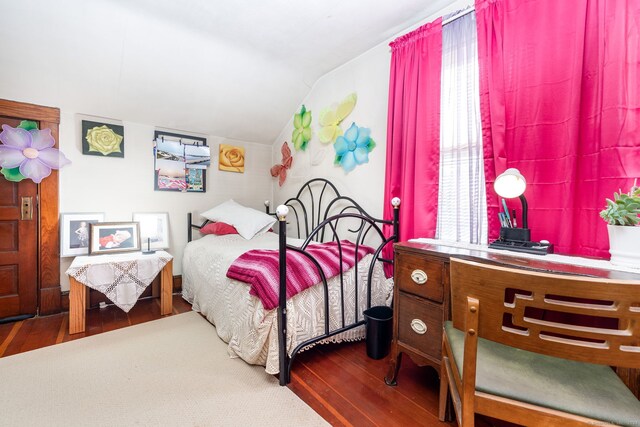 bedroom with hardwood / wood-style floors and vaulted ceiling