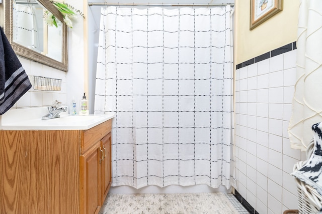 bathroom with tile walls, vanity, and shower / tub combo with curtain